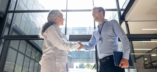 Man shaking woman doctor's hand