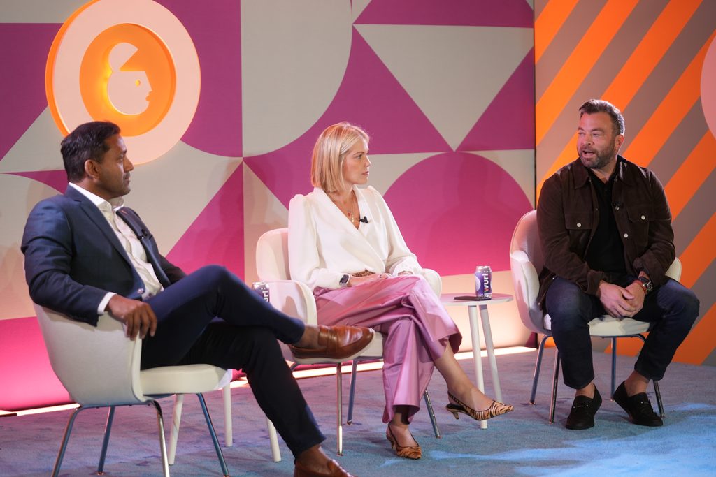 Three people sitting on a panel at Advertising Week New York
