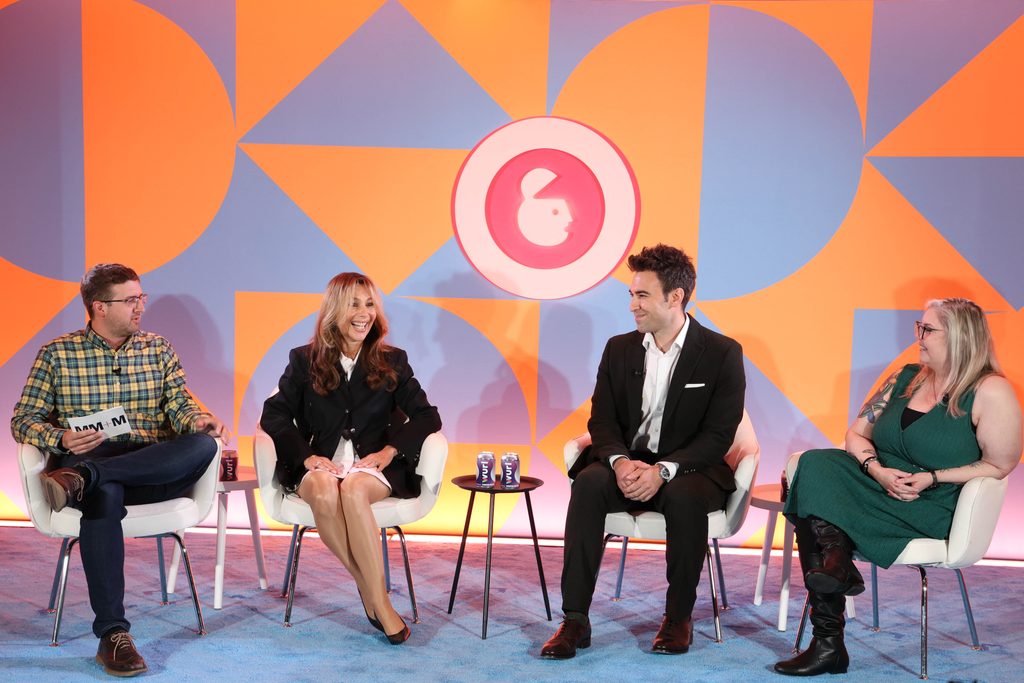 Four people sitting on a panel at Advertising Week New York