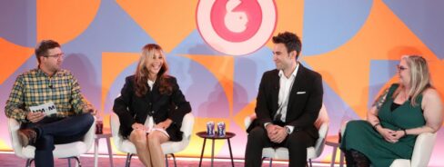 Four people sitting on a panel at Advertising Week New York
